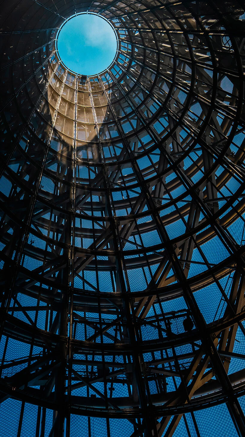 Looking up inside one of the museum's steel-mesh cones toward the open oculus