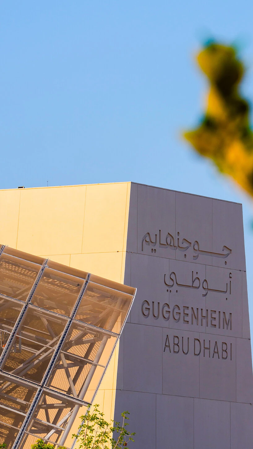 The Guggenheim Abu Dhabi name stele in Arabic and English beside the water