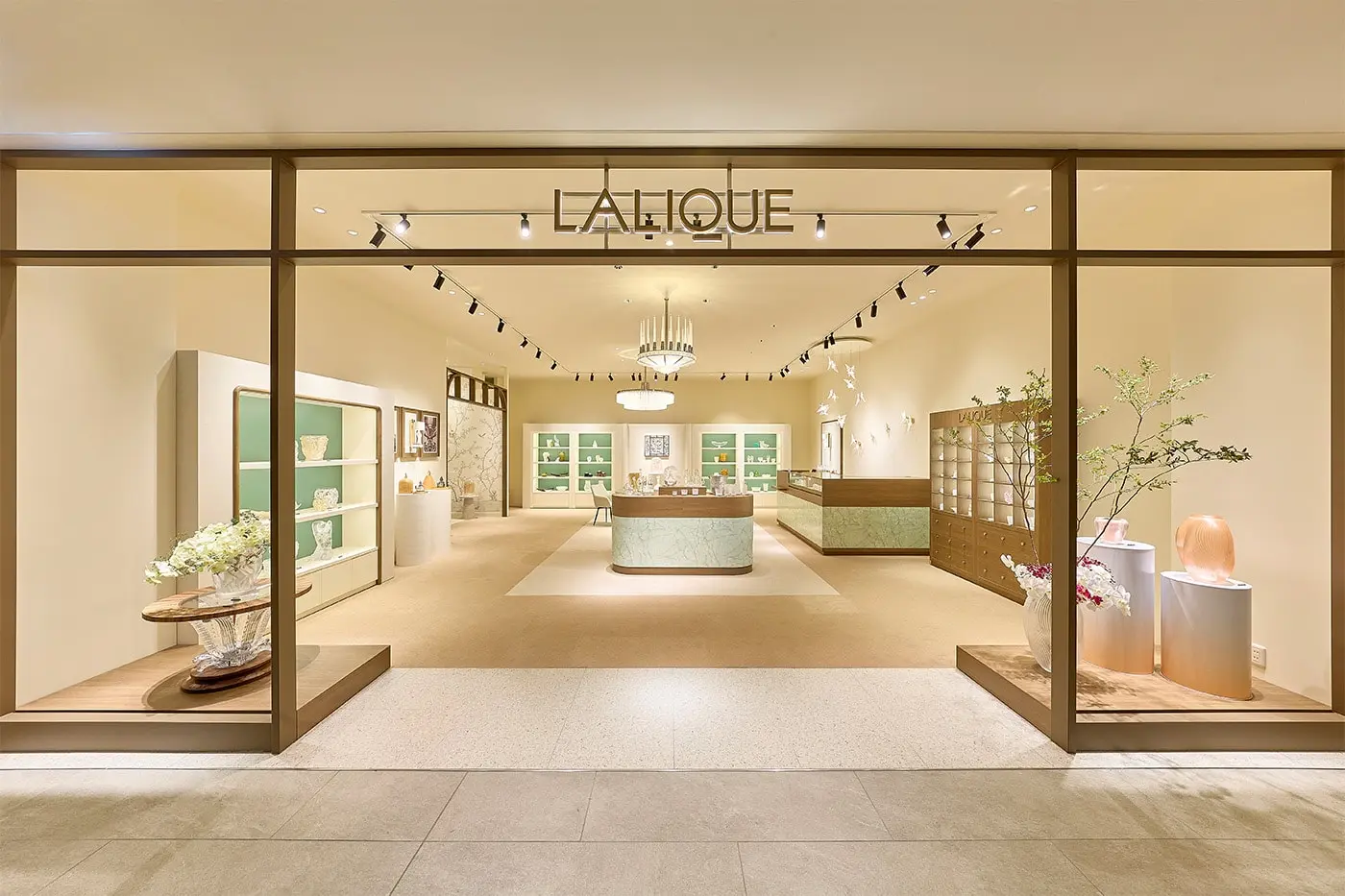 Interior view of Lalique Osaka boutique at Quartz Shinsaibashi showing crystal display cases and chandelier installation