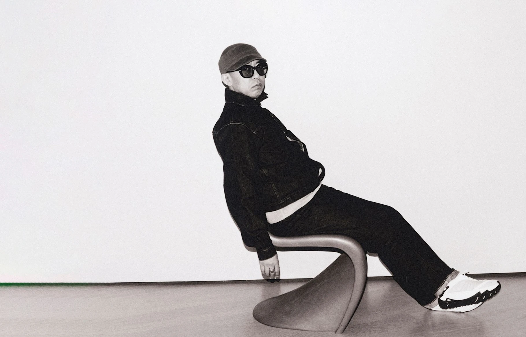 NIGO seated in a Panton chair, the Design Museum's key image for the From Japan with Love retrospective