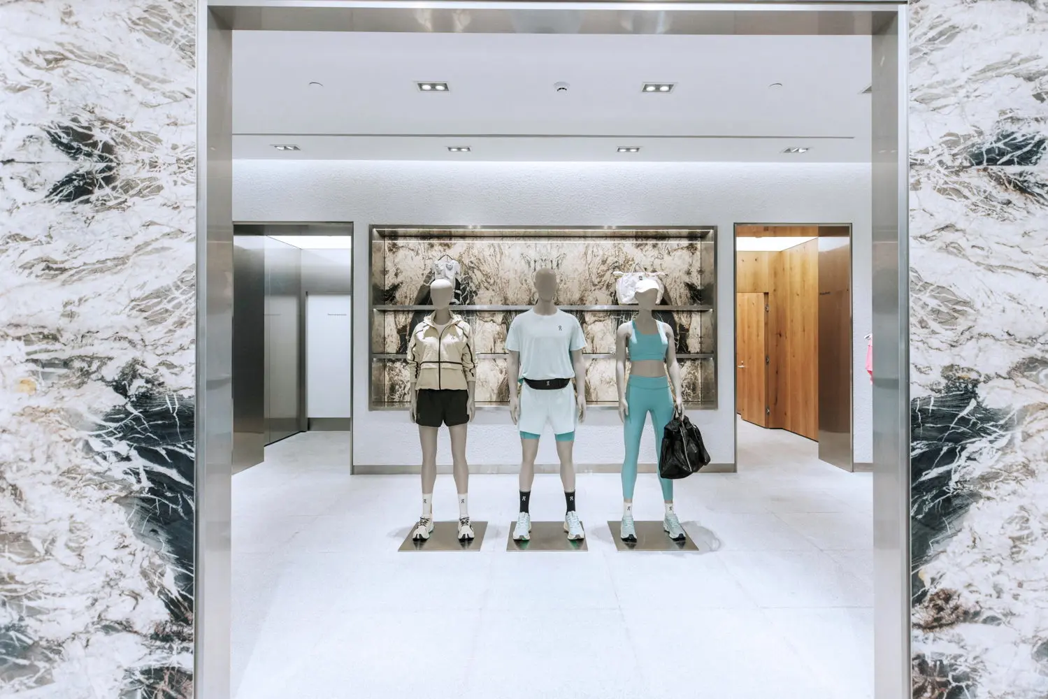 Interior of On's new retail store in Parque Arauco mall, Santiago, Chile, showing shoe display walls and open floor layout
