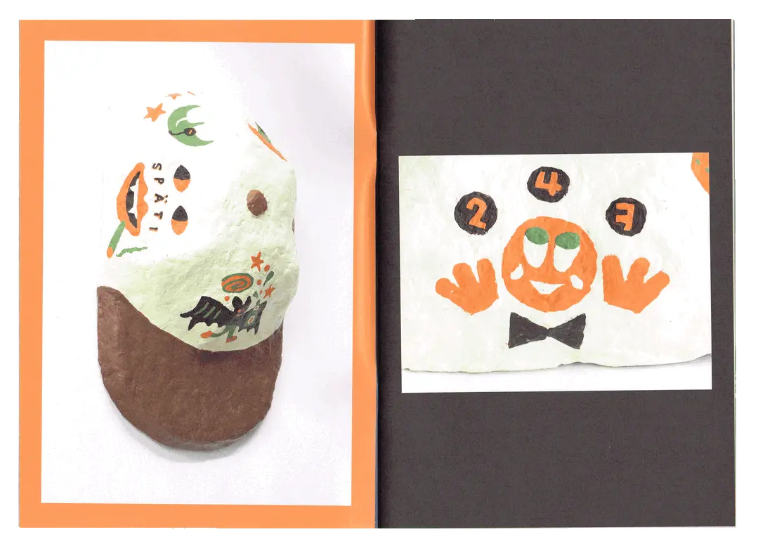 One of the papier-mache caps displayed next to the accompanying zine.